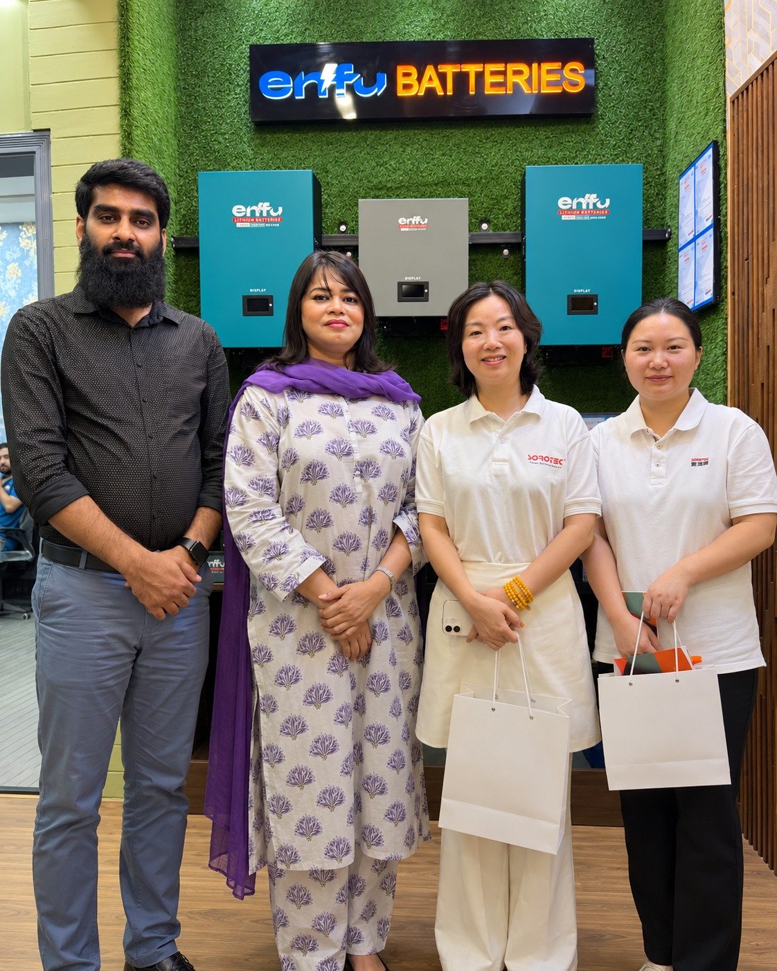 Visitors at the Enfu Batteries showroom wall